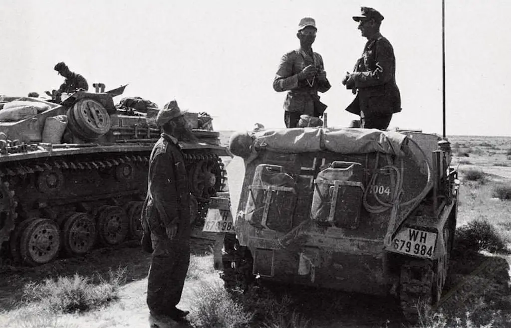 General Ulrich Kleemann, German 90th Light Division speaks to a photographer on a SdKfz. 250 half-track command vehicle.