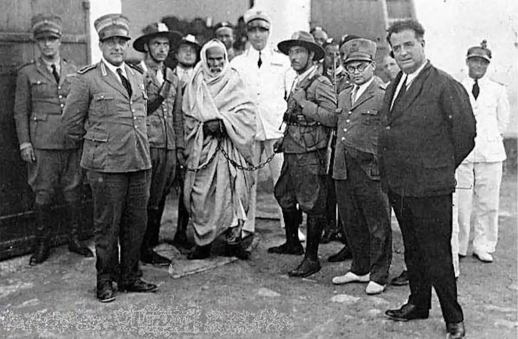 Omar Mokhtar arrested and in chains prior to his execution.