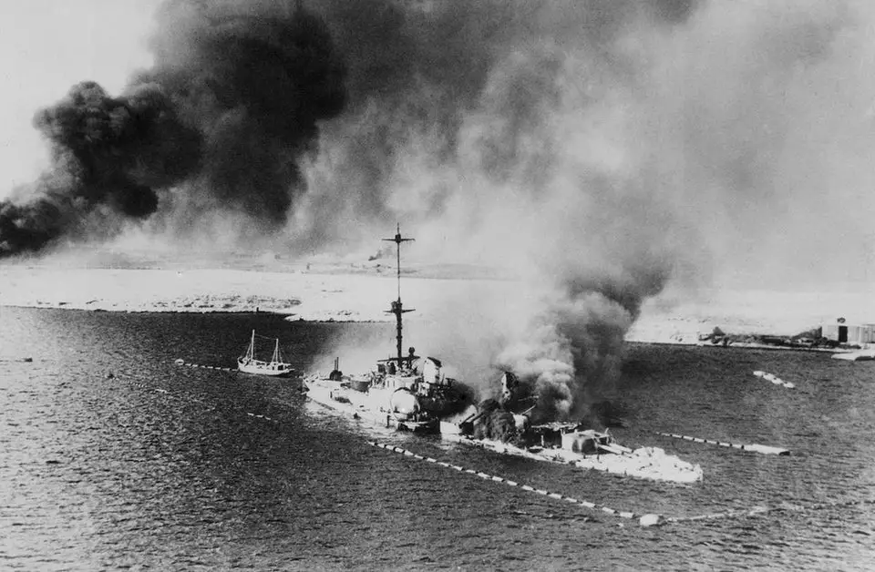 The San Giorgio in flames after being scuttled on 22 January 1941.