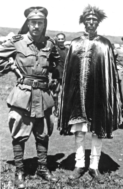 Amedeo with an important Ethiopian chief wearing. the lion mane head dress (1939).