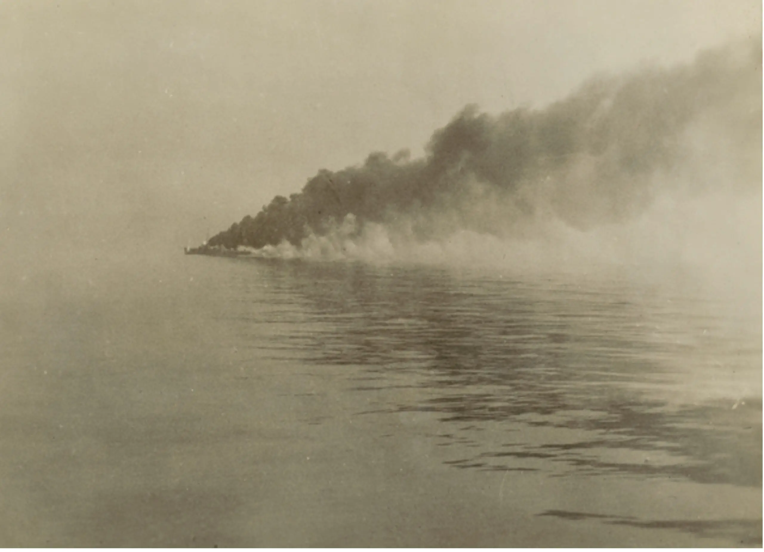 Figure 1 Espero making smoke, photo taken from HMAS Sydney (Australian War Memorial)