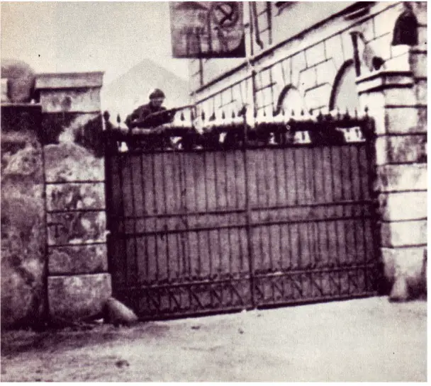 an armed worker stands guard in front of the entrance of a factory