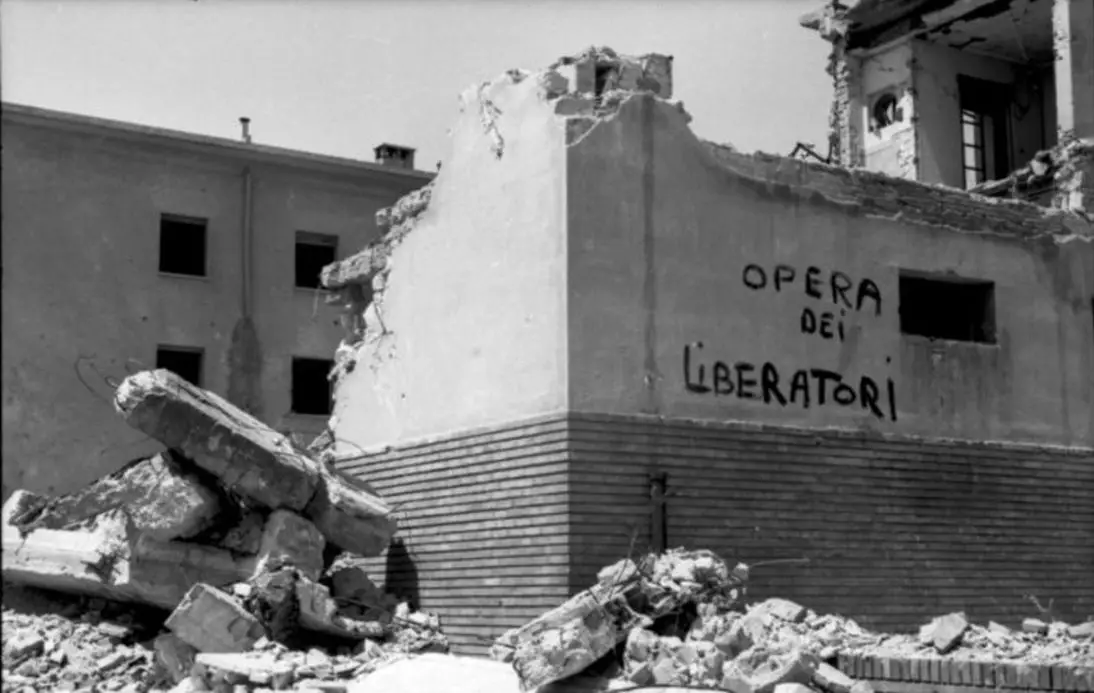 “work of the liberators”, written on the side of a destroyed house in Rome